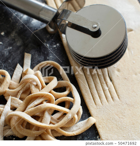 Making taglatelle with a pasta rolling cutter 50471692