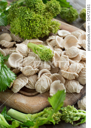 Raw homemade Orecchiette pasta and turnip greens 50472381