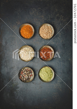 Various bowls of spices over dark background Various bowls of spices over dark background 50472701