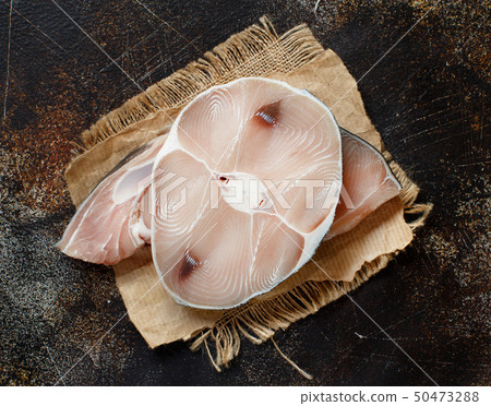 Two shark steak on a dark board Two shark steak on a dark board 50473288