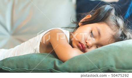 The little girl is sleeping on the bed. The little girl is sleeping on the bed. 50475292