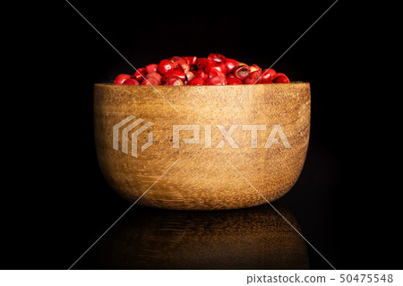 Pink peruvian pepper isolated on black glass Pink peruvian pepper isolated on black glass 50475548