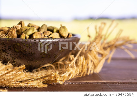 True cardamom pod with field behind 50475594