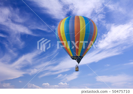 Colorful hot-air balloon flying in the blue sky 50475710