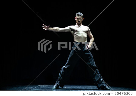 female muscular ballroom dancer making pose isolated on black 50476303
