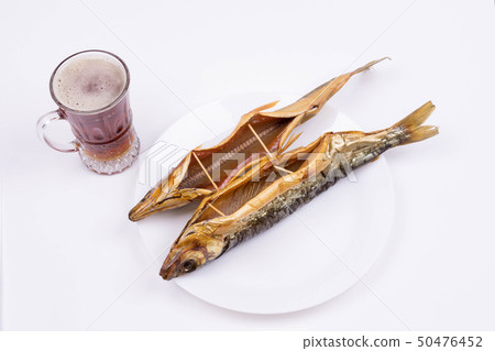 two omul on a plate, with a glass of dark beer two omul on a plate, with a glass of dark beer 50476452