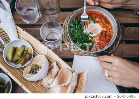 Shakshuka, Fried Eggs in Tomato Sauce on the Table Shakshuka, Fried Eggs in Tomato Sauce on the Table 50476496