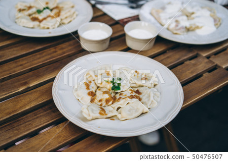Dumplings with bacon and herbs on a plate Dumplings with bacon and herbs on a plate 50476507