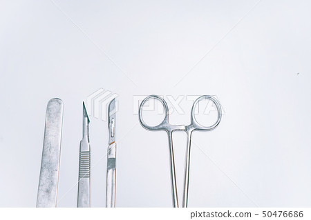 Scapula for throat, two scalpels and clamp on a light background 50476686