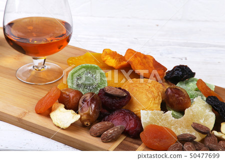 Organic Healthy Assorted Dried Fruit and glasses with cognac or whiskey on wine board. Selective Organic Healthy Assorted Dried Fruit and glasses with cognac or whiskey on wine board. Selective 50477699