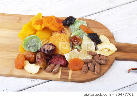 Organic Healthy Assorted Dried Fruit on wine board. Selective focus. Organic Healthy Assorted Dried Fruit on wine board. Selective focus. 50477701