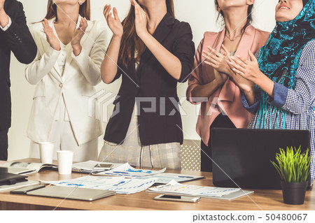 Business people applauding in a business meeting. 50480067