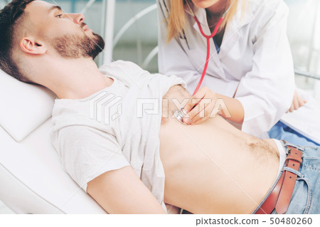 Woman Doctor and Male Patient in Hospital Office 50480260
