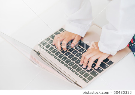 Close up shot of little kid using laptop computer 50480353