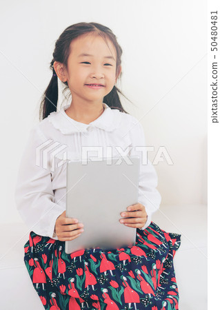 Little kid on white background with tablet. Little kid on white background with tablet. 50480481