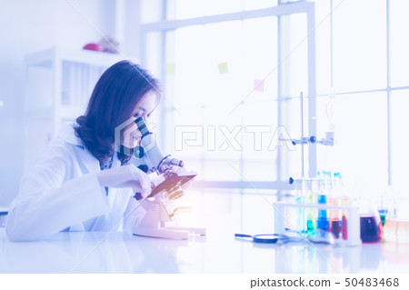 Asian scientist look throgh microscope.. Asian scientist look throgh microscope.. 50483468