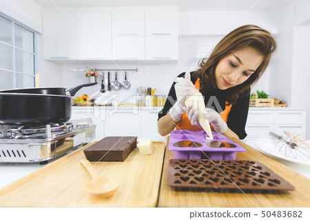 Woman making chocolate Woman making chocolate 50483682