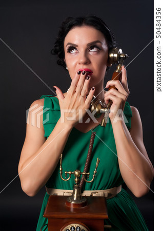 Pretty woman with retro phone 50484356