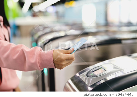Woman scan train ticket to subway entrance gate 50484443