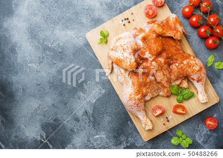 Raw chicken tobacco on a wooden Board with spices  50488266