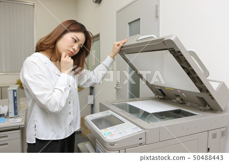 Office lady operating copy machine Office lady operating copy machine 50488443