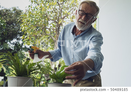 senior man happiness take care of flower at 50489185