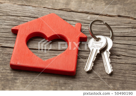 Wooden red house and keys on the old wooden boards Wooden red house and keys on the old wooden boards 50490190