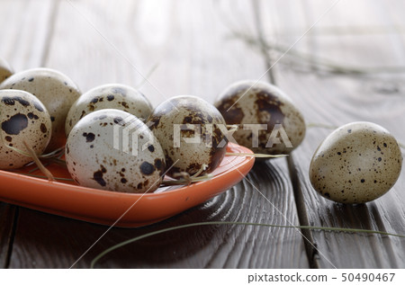 Fresh organic quail eggs in orange clay plate on Fresh organic quail eggs in orange clay plate on 50490467