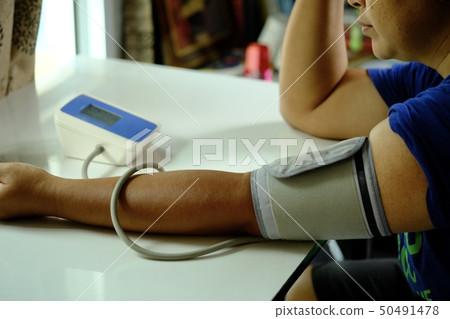 Women pressure measuring by herself. 50491478