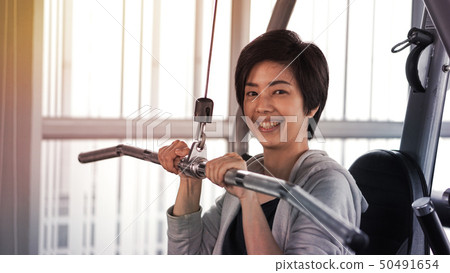 Asian short hair woman fitness training machine 50491654