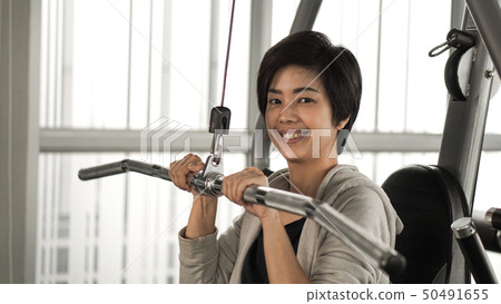 Asian short hair woman fitness training machine 50491655