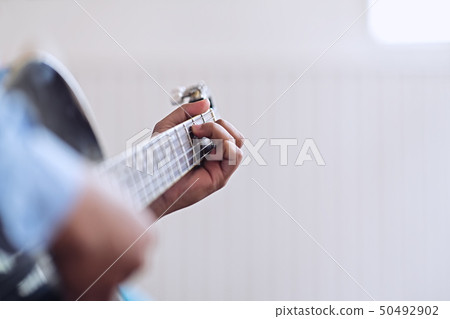 Man playing guitar. Practicing in playing guitar 50492902