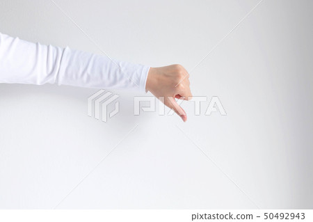 Hand showing thumb down gesturing dislike, unlike. 50492943