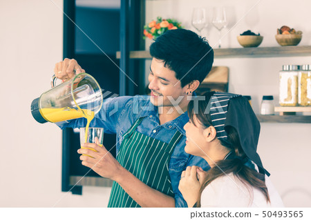 YOUNG COUPLE IN KITCHEN 50493565
