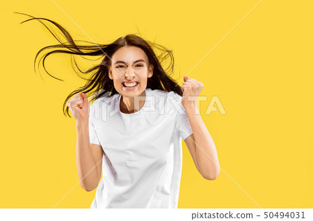 Portrait of beautiful woman isolated on yellow studio background Portrait of beautiful woman isolated on yellow studio background 50494031