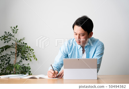 Man taking online classes 50494362