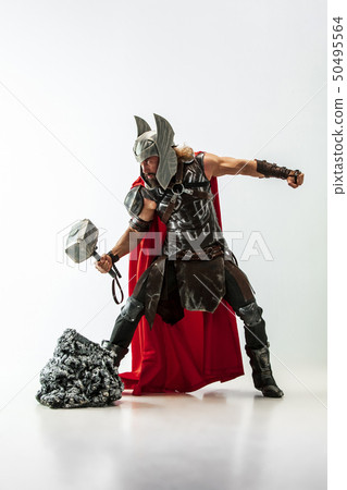 Man in cosplaying Thor isolated on white studio background Man in cosplaying Thor isolated on white studio background 50495564