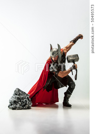 Man in cosplaying Thor isolated on white studio background Man in cosplaying Thor isolated on white studio background 50495573