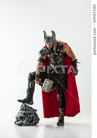 Man in cosplaying Thor isolated on white studio background Man in cosplaying Thor isolated on white studio background 50495589