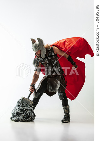 Man in cosplaying Thor isolated on white studio background Man in cosplaying Thor isolated on white studio background 50495598