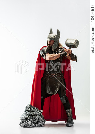 Man in cosplaying Thor isolated on white studio background Man in cosplaying Thor isolated on white studio background 50495615