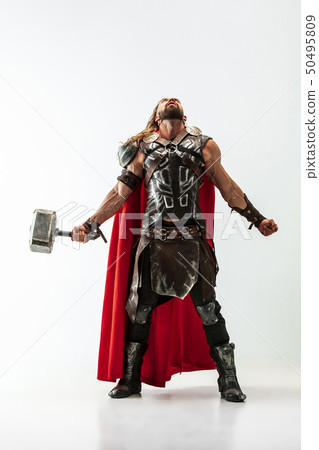 Man in cosplaying Thor isolated on white studio background 50495809