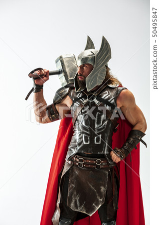 Man in cosplaying Thor isolated on white studio background Man in cosplaying Thor isolated on white studio background 50495847