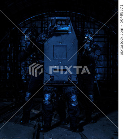 SWAT team members covering with ballistic shield 50499571