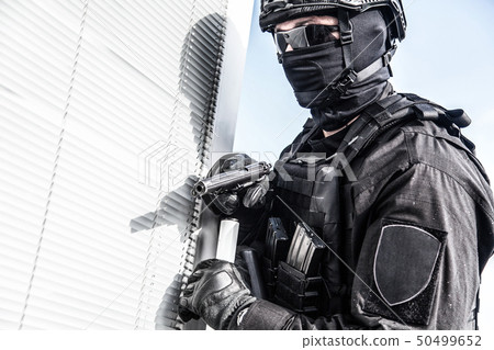 Police SWAT armed fighter ready to break in room Police SWAT armed fighter ready to break in room 50499652