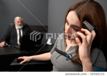 Woman leaning head on hand with finger sensor. Woman leaning head on hand with finger sensor. 50500133