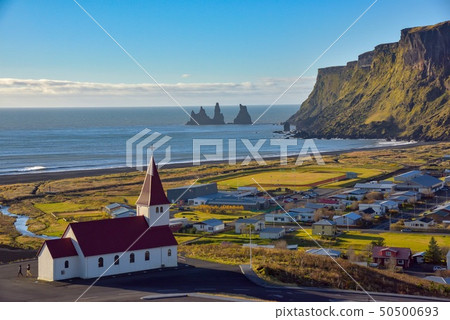 Icelandic town Vik and the rock formation towering in the sea 50500693