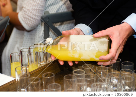 serving limoncello in glasses 50500869