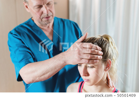 The visceral doctor is engaged in manual editing of the skull of a young girl. Alternative medicine 50501409