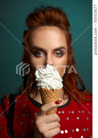Pretty model holding delicious white ice cream. 50503677